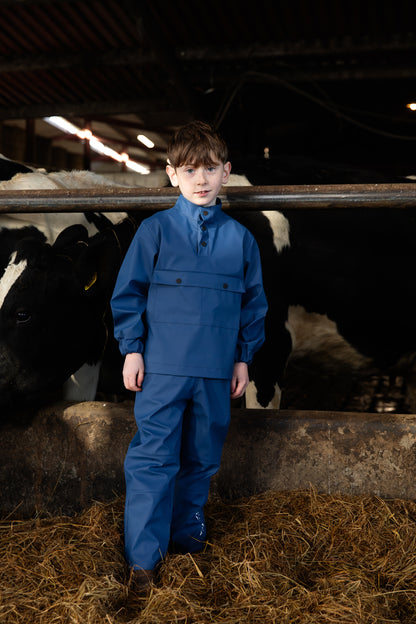 Child n front of cows wearing wawets waterproof dairy top & pants